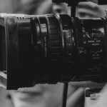 How we protect whistleblowers and source integrity Street photojournalists recording urban events with professional cameras in black and white.
